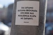 a sticker on a pole on a city street