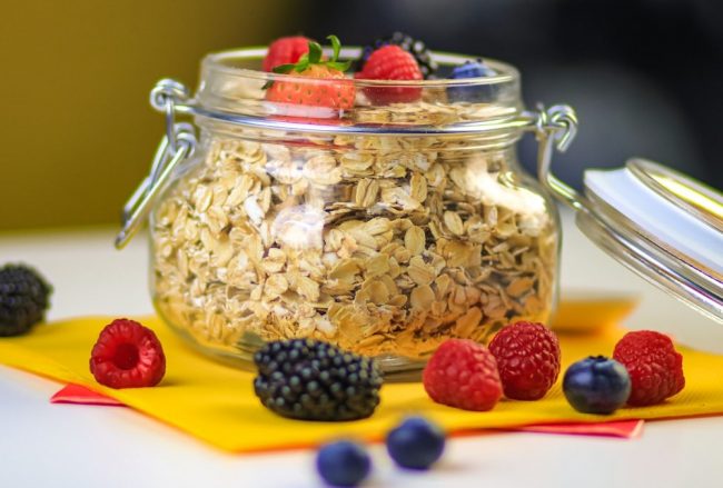 clear glass jar with black berries
