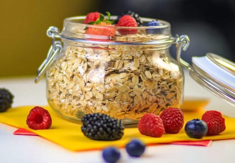 clear glass jar with black berries